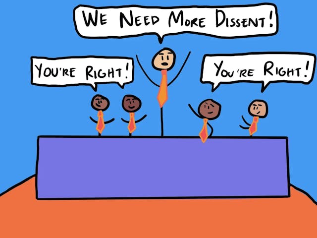 Cartoon figures wearing orange ties stand behind a blue desk. One figure exclaims, "We need more dissent!" while two others respond, "You’re right!" Background is blue and orange.