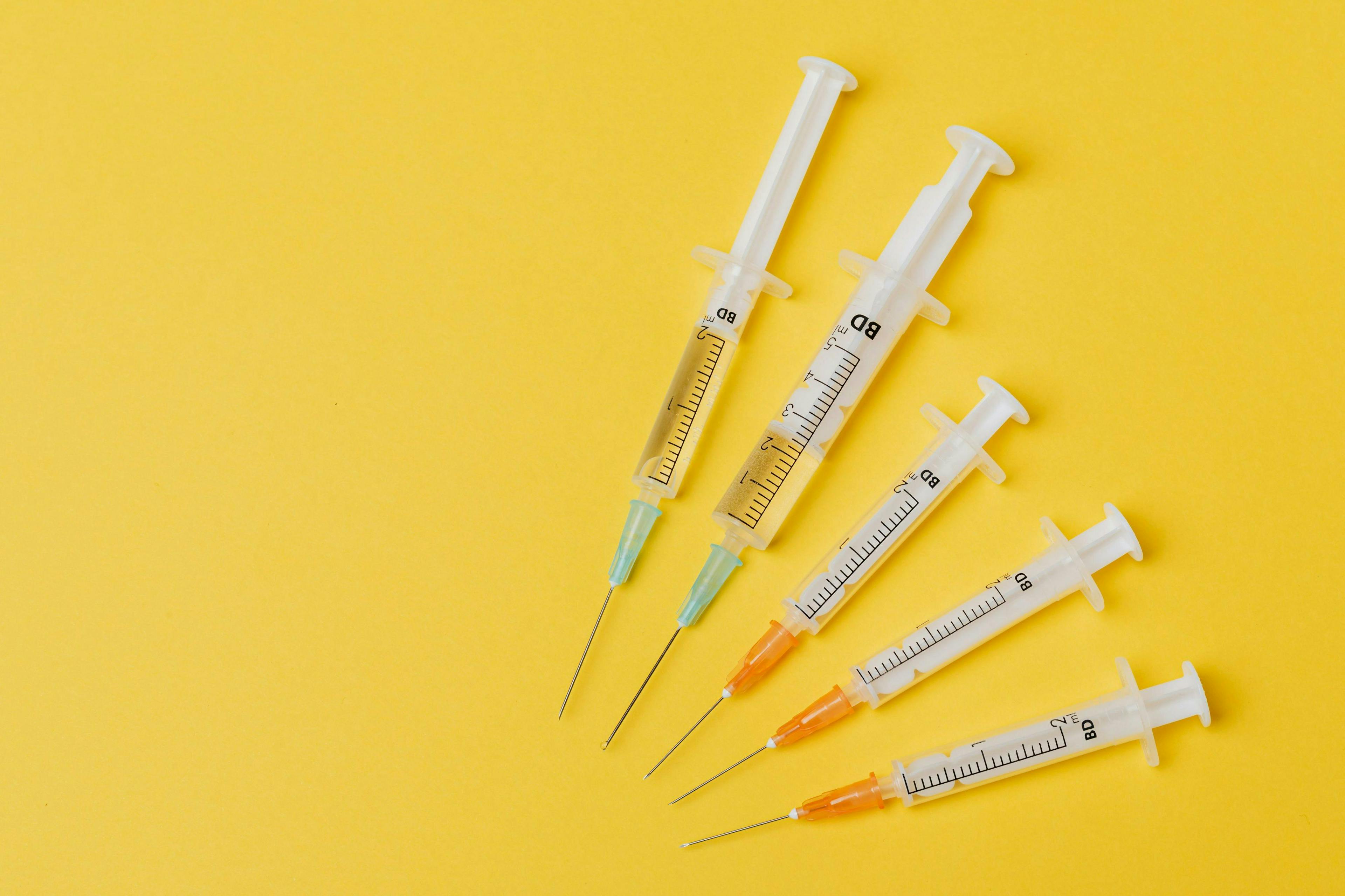vaccines on yellow background