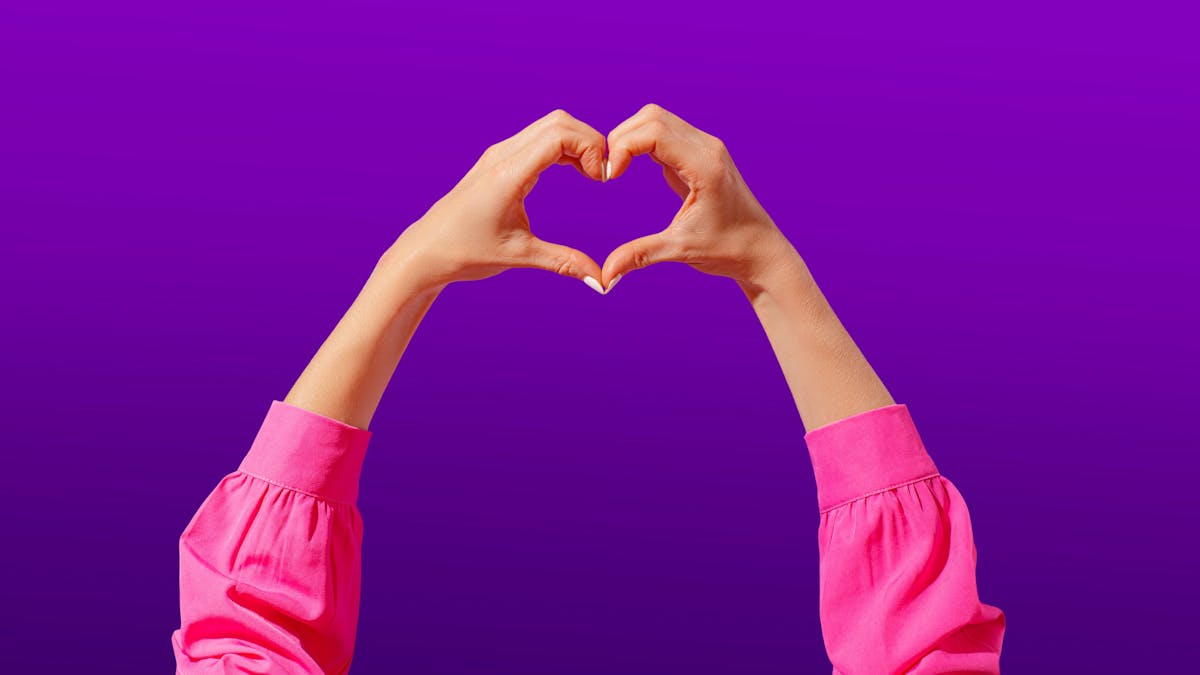 Two hands forming a heart shape on a purple gradient background
