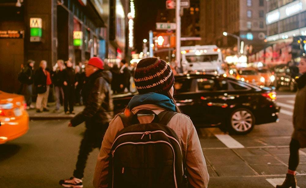 woman in a backpack walking in the city