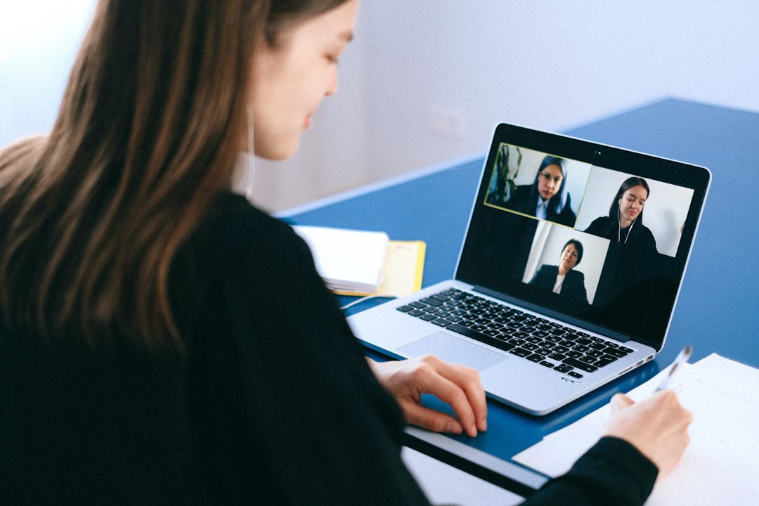 Woman having a video meeting with coworkers
