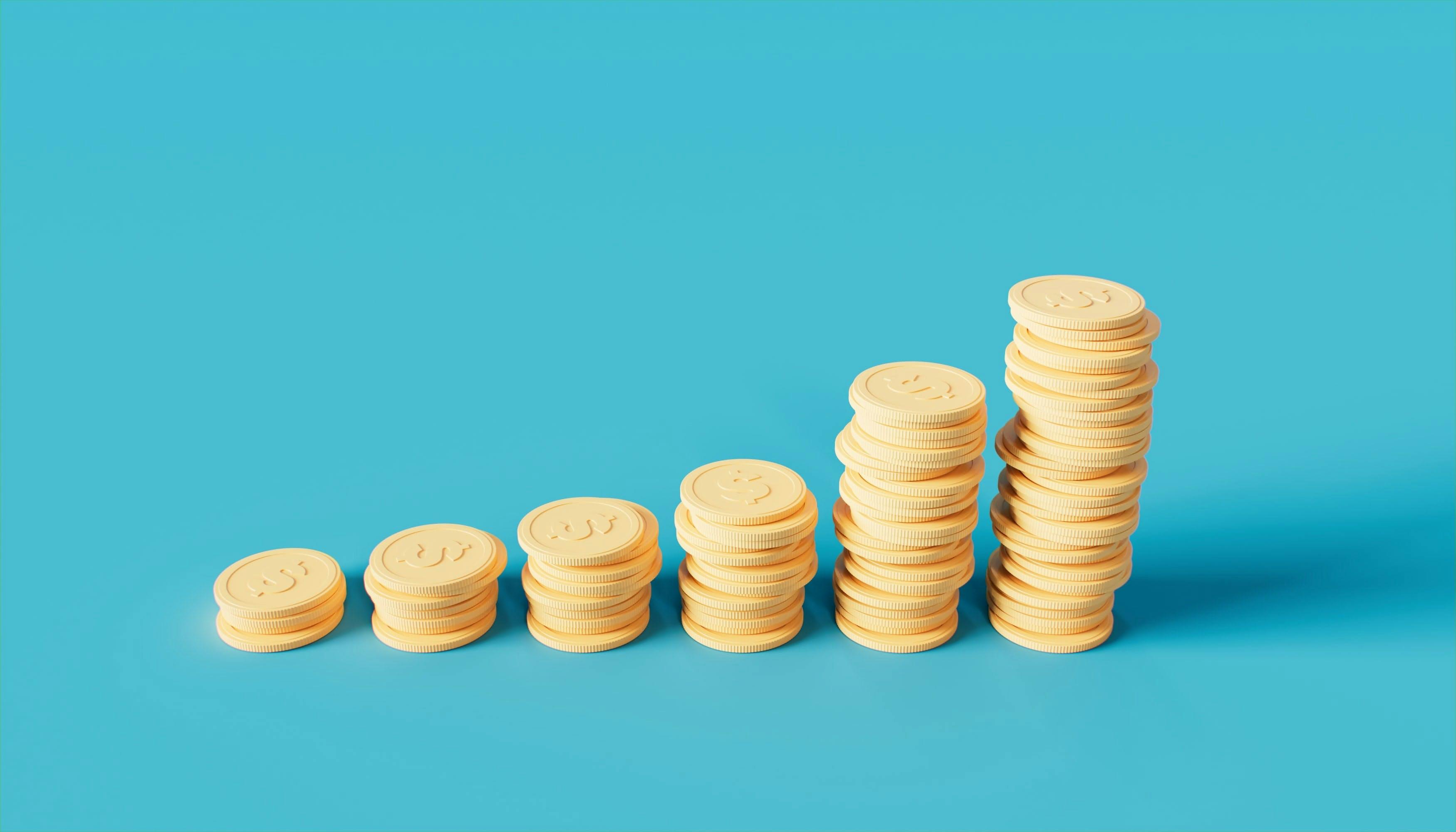 Stacks of yellow coins on top of a blue background.