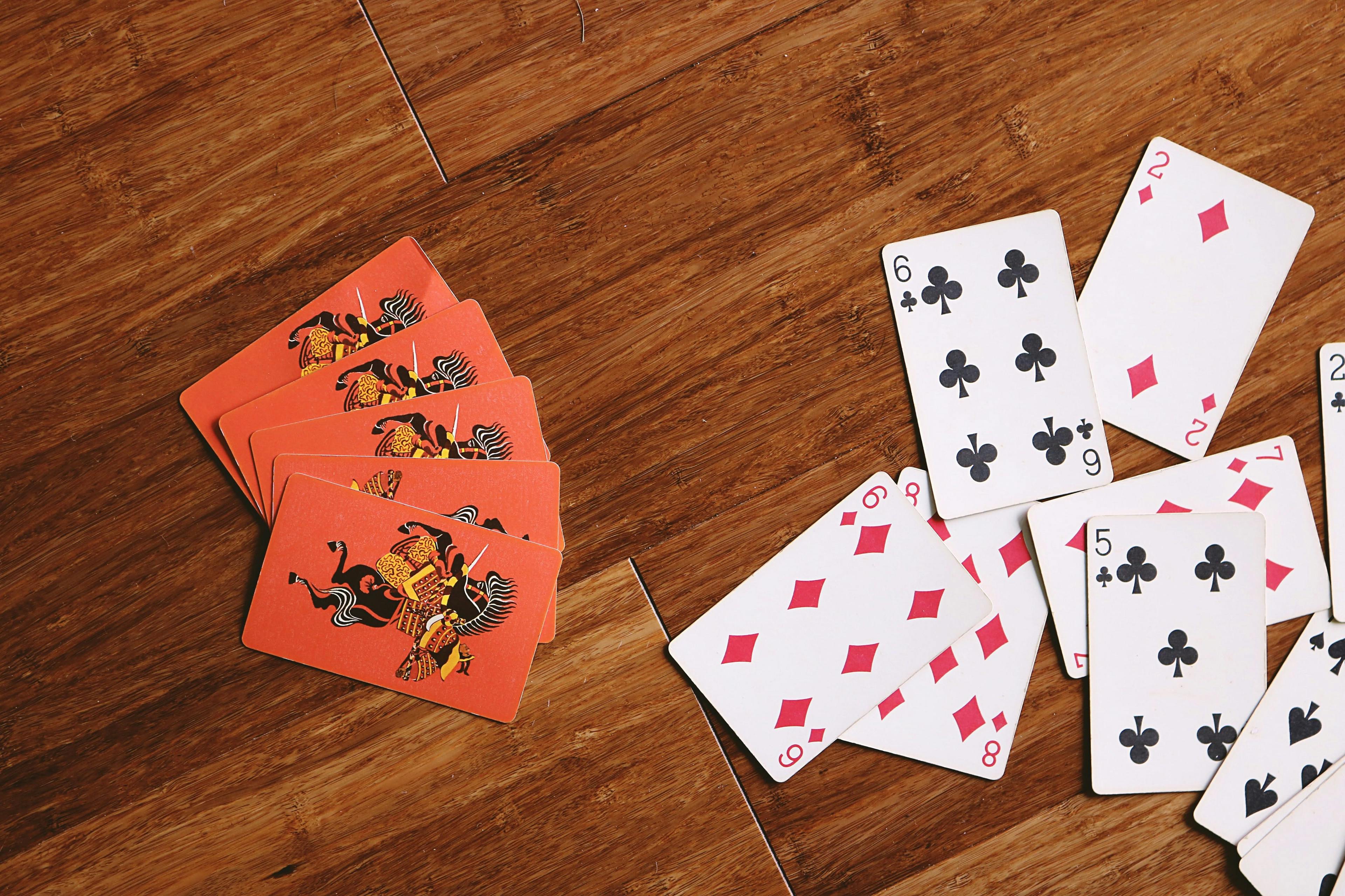 playing cards on a wooden surface
